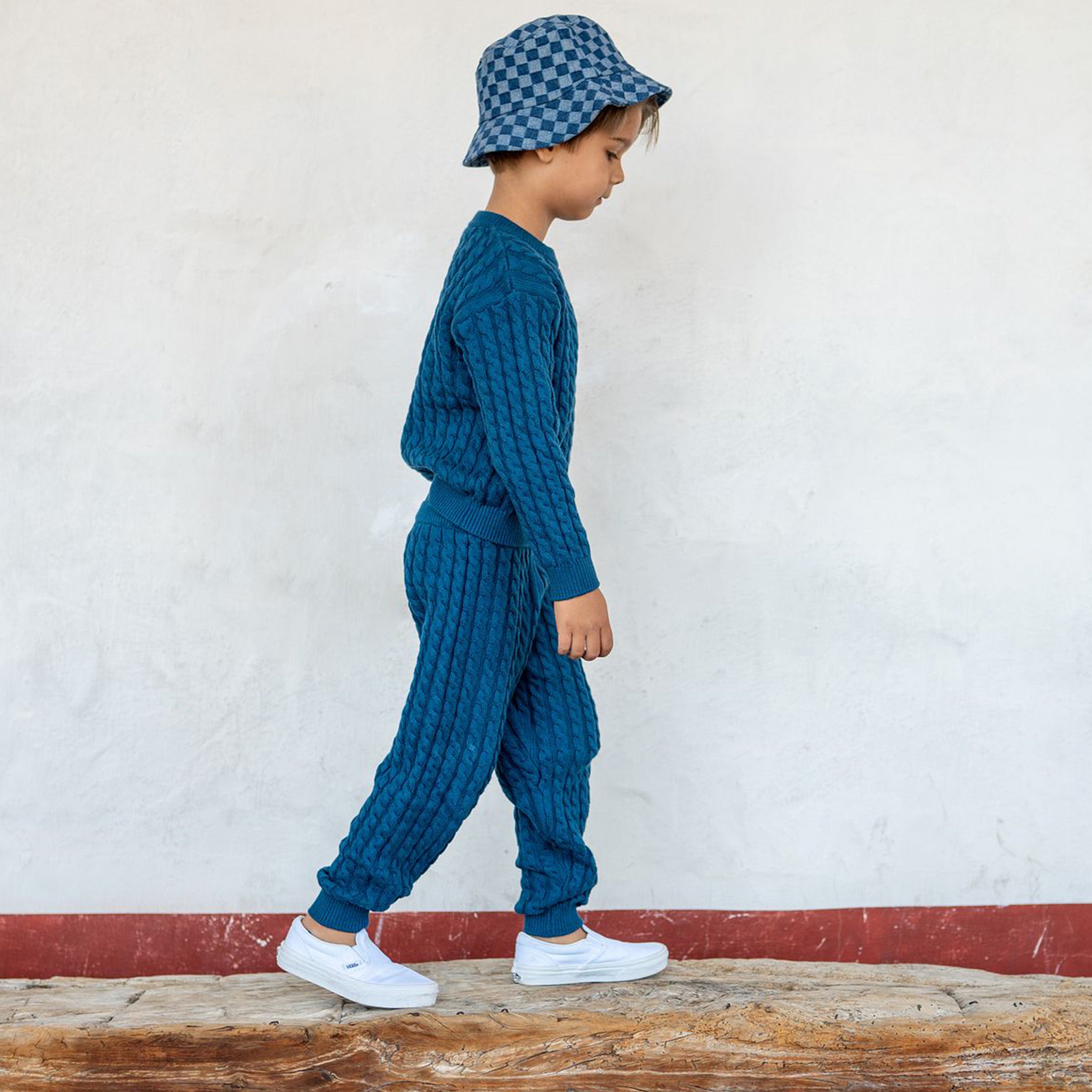 Happy cable knit sweater and pants side view. 