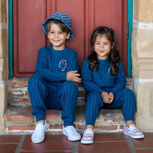 Kids wearing happy cable knit sweater and pants. 