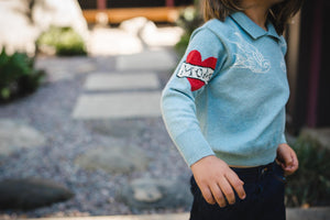 Close up of kids chambray blue sailor sweater with collar. 