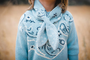 Close up of chambray blue bandana print kids scarf.