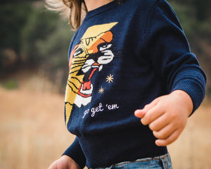 Close up of kids navy blue tiger and lightning bolt sweater. 