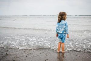 Back of kids light blue tie dye sweater and shorts. 