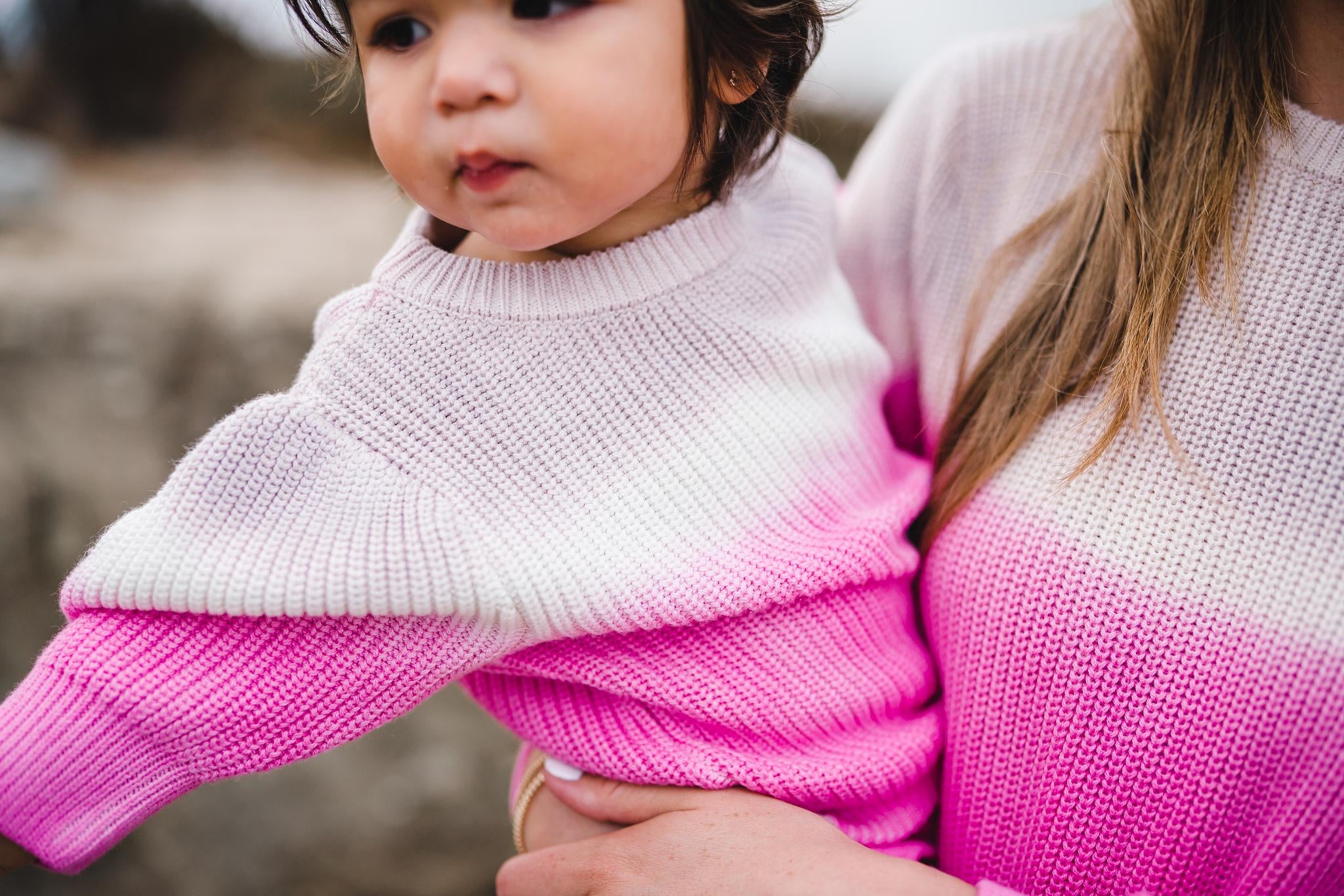 Close up of kids and women's matching pink dip dye sweater.