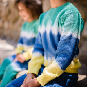 Green, blue and yellow dip dye sweater close up.